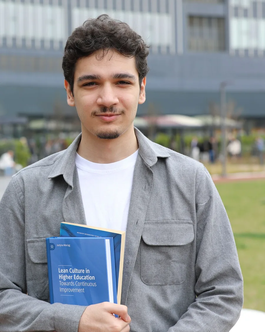 A Verba student holding a copy of Master the Language with Verba